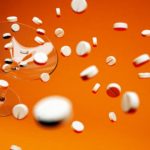 Photo of an Empty Cocktail Glass and Pills