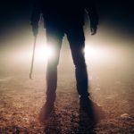 violence 3 Male Figure Wielding a Crowbar in the Dark with a Car Reflector Background