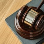 Wooden Gavel sitting on a table.