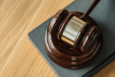 Wooden Gavel sitting on a table.